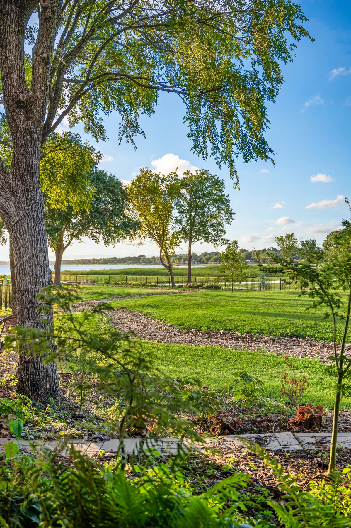 Open garden and lawn stretching toward the Cedar Creek Lake shoreline