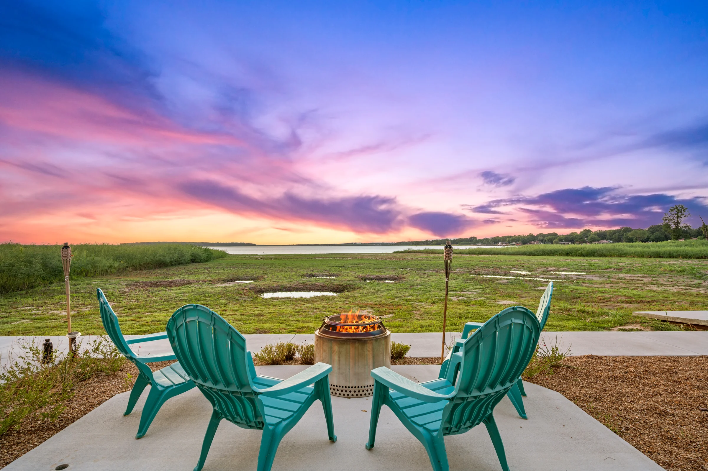 Firepit seating overlooking Cedar Creek Lake at sunset